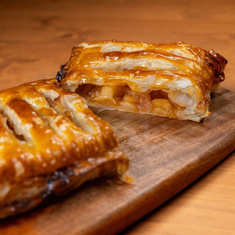 Glazed, scored apple chausson turnovers on a cooling rack