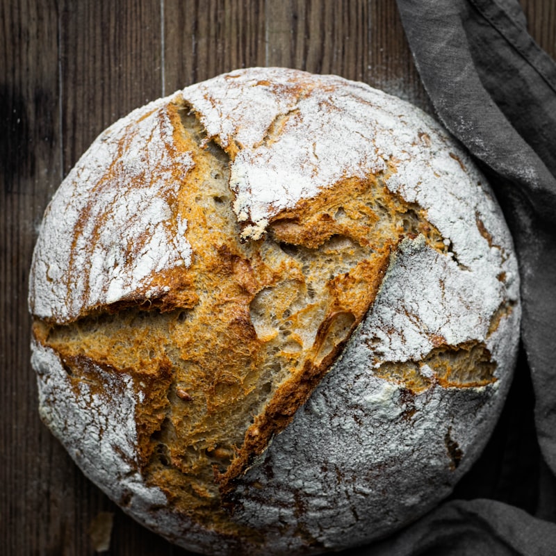 A round sourdough loaf with a dark, scored crust