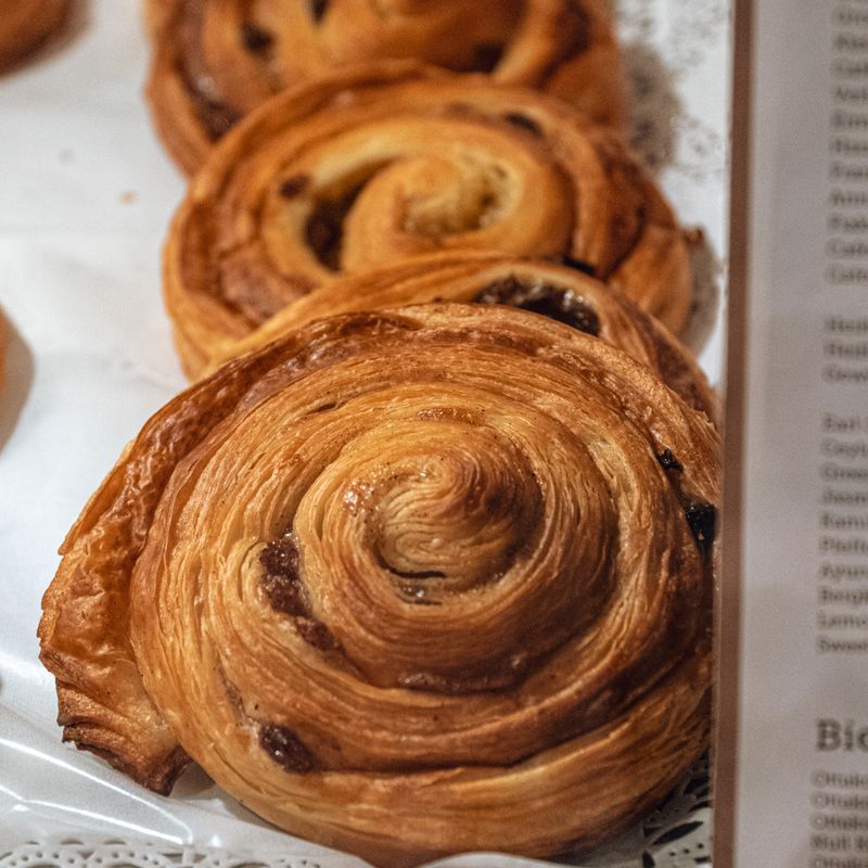 A spiral escargot raisin pastry studded with raisins