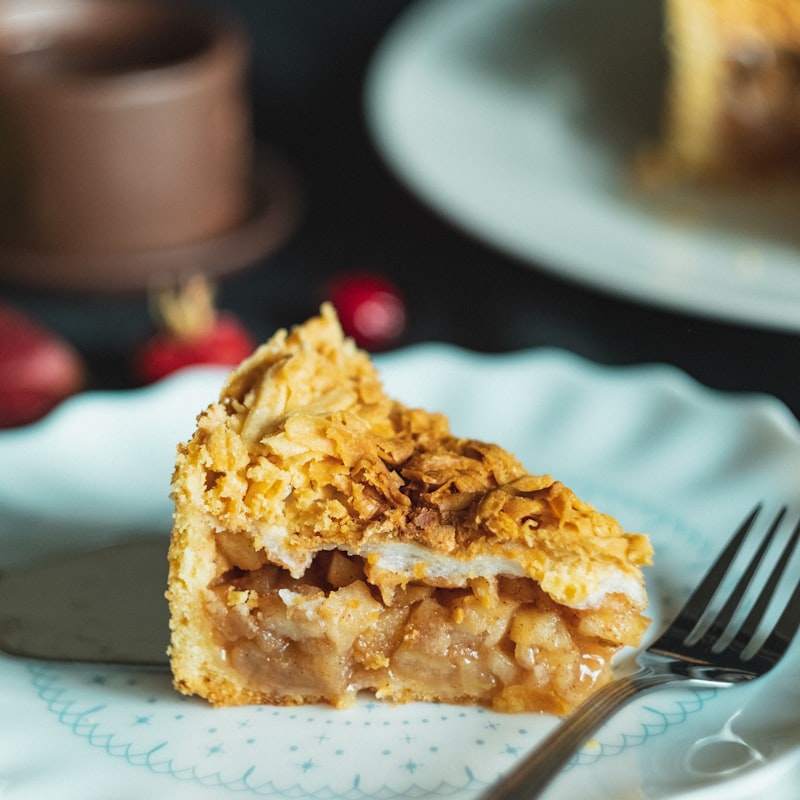 A slice of apple pie with a golden crumble topping